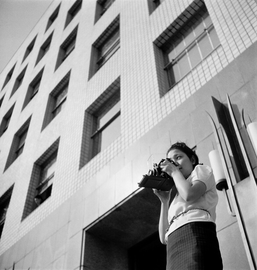 Photograph of a woman in Tokyo city in the 1940s with a camera Photographer unknown, Tsuneko Sasamoto, Tokyo, 1940, printed 2020, inkjet print, Tsuneko Sasamoto/Japan Professional Photographers Society